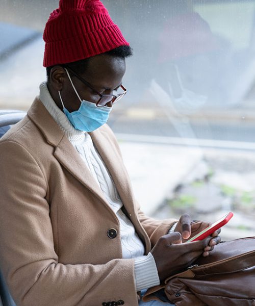 african-american-traveler-man-using-phone-wear-fac-8HSRZ48